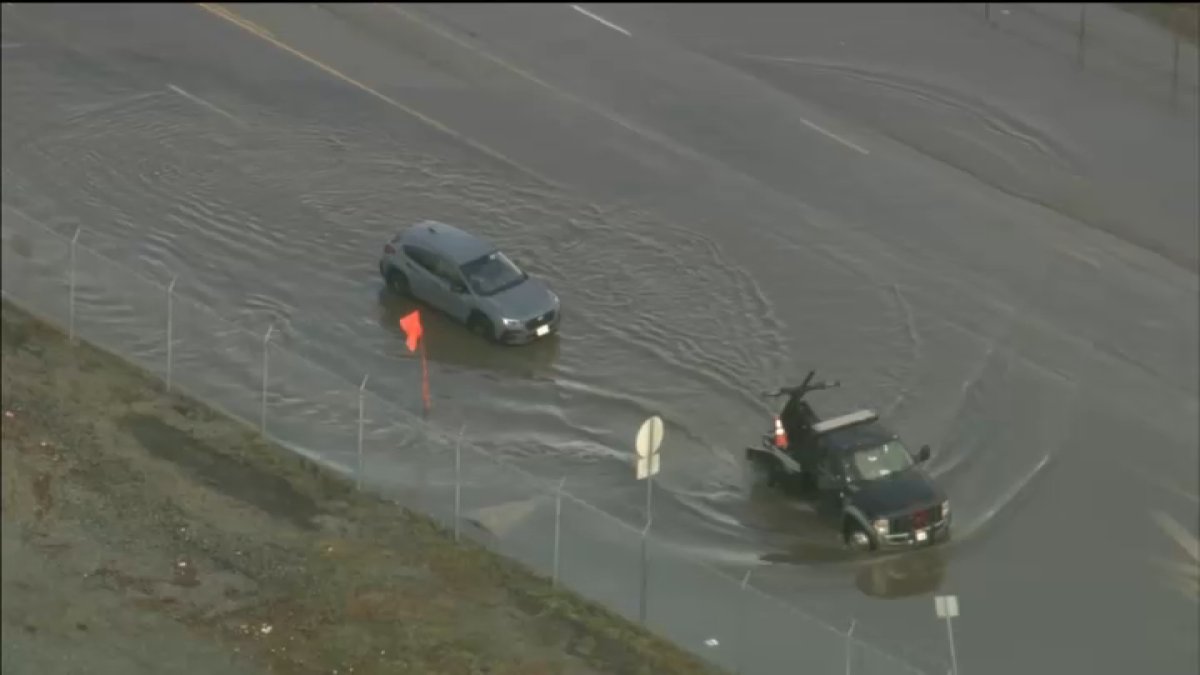 Two cars stuck in flooded roadway in North Hollywood