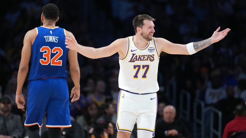 Los Angeles Lakers guard Luka Doncic (77) and New York Knicks center Karl-Anthony Towns (32) react in the second half at Crypto.com Arena.