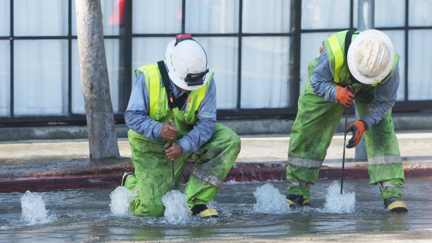 Crews work to fix a water main break that flooded a swath of West Hollywood.