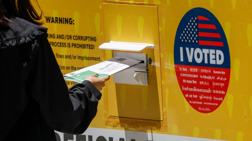 A person places their Mail in ballot into a ballot box during early voting outside of the LA County Registrar-Recorder building on Monday, June 1, 2026 in Norwalk, CA.