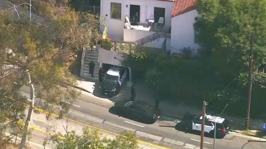 Police at the scene of a shooting at a Hollywood Hills home.