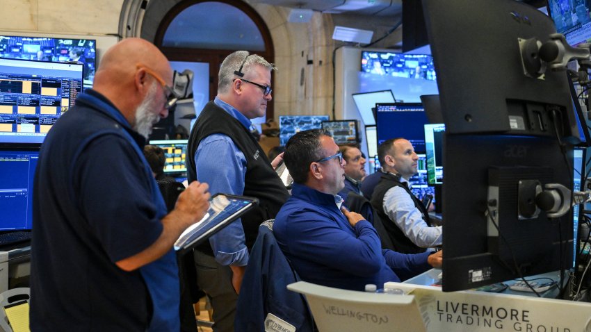 Traders work on the floor of the New York Stock Exchange (NYSE) at the opening bell in New York on July 27, 2026.