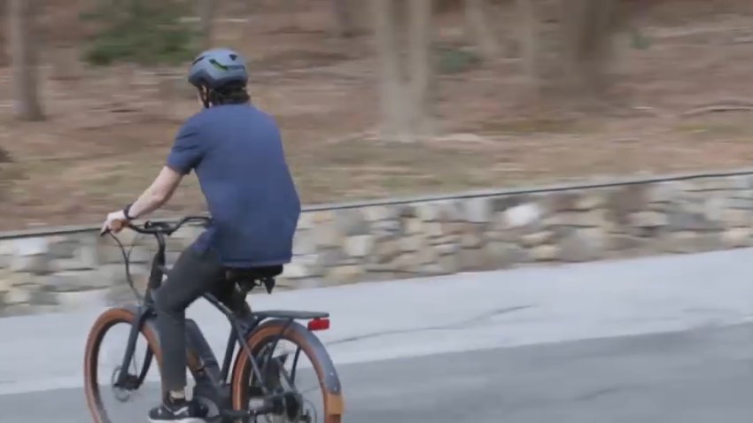 A person travels on an e-bike.