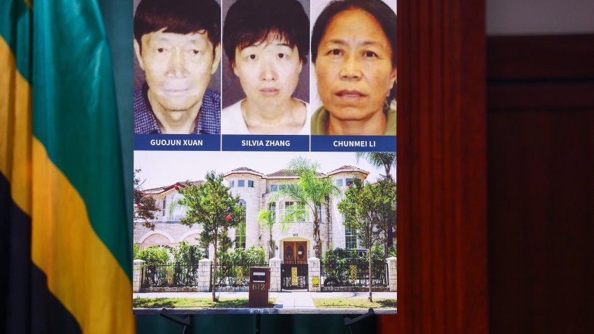Los Angeles, CA – October 06: Three of the people who have been arrested as part of an investigation into 20 children through surrogates been kept under constant surveillance at a sprawling mansion has been arrested on abuse and witness intimidation charges are seen on a display board during a press conference at Hall of Justice  on Tuesday, Oct. 6, 2026 in Los Angeles, CA. (Ronaldo Bolaños / Los Angeles Times via Getty Images)