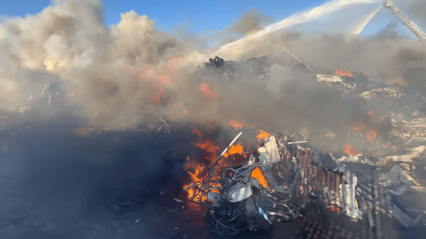 Fire burns at a metal scrap yard in Fontana.