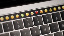 In this file photo, emoticons are displayed on the Touch Bar on a new Apple MacBook Pro laptop during a product launch event on October 27, 2016 in Cupertino, California.