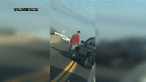 Video shows a SUV flip onto its side during a road rage confrontation on a California freeway.