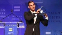 Adam Rippon celebrates as he is honored with the Visibilty Award during the Human Rights Campaign 2018 Los Angeles Dinner at JW Marriott Los Angeles at L.A. LIVE on March 10, 2018 in Los Angeles, California. That night he and Sally Field
