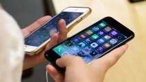 FILE - In this Friday, Sept. 16, 2016, file photo, Lisa Gao compares a black iPhone 7, right, with her iPhone 6 at the Apple Store on Michigan Avenue, in Chicago. Apple, Samsung and other phone companies keep coming out with more powerful phones with better cameras and a bevy of bells and whistles. Rather than relegate an earlier model to a desk drawer, consider donating, reusing, recycling or reselling it.