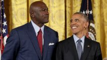 In this Nov. 22, 2016, file photo, President Barack Obama smiles up at legendary basketball star Michael Jordan before awarding him the Presidential Medal of Freedom during a ceremony in the East Room of the White House.