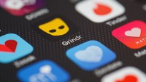 This Nov. 24, 2016, file photo shows the "Grindr" app logo on a mobile phone screen in London, England.