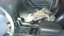 A view inside of the white Jeep Cherokee stopped in the middle of a Parkland intersection.