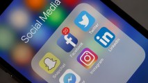 In this May 12, 2018, file photo, logos of the Snapchat, Facebook, Twitter, Messenger, Instagram and LinkedIn applications are displayed on the screen of an Apple iPhone in Paris, France.