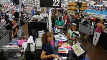 This Aug. 14, 2008, file photo shows a checkout aisle at a Walmart store in North Miami, Florida.